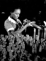 Photo, "Bertha Stallworth, age 21, shown inspecting end of 40mm artillery cartridge case at Frankford Arsenal," No date Photo, "B Stallworth, age 21, with 40mm artillery cartridge case," No date